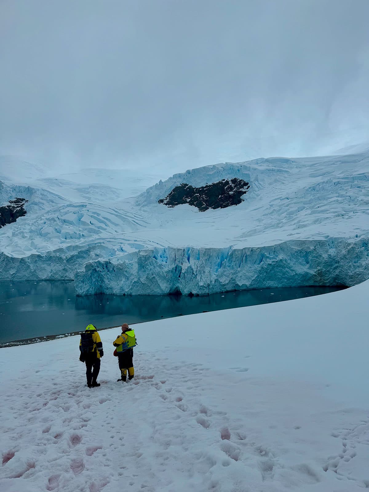 Expedition guides monitoring an icy landing area