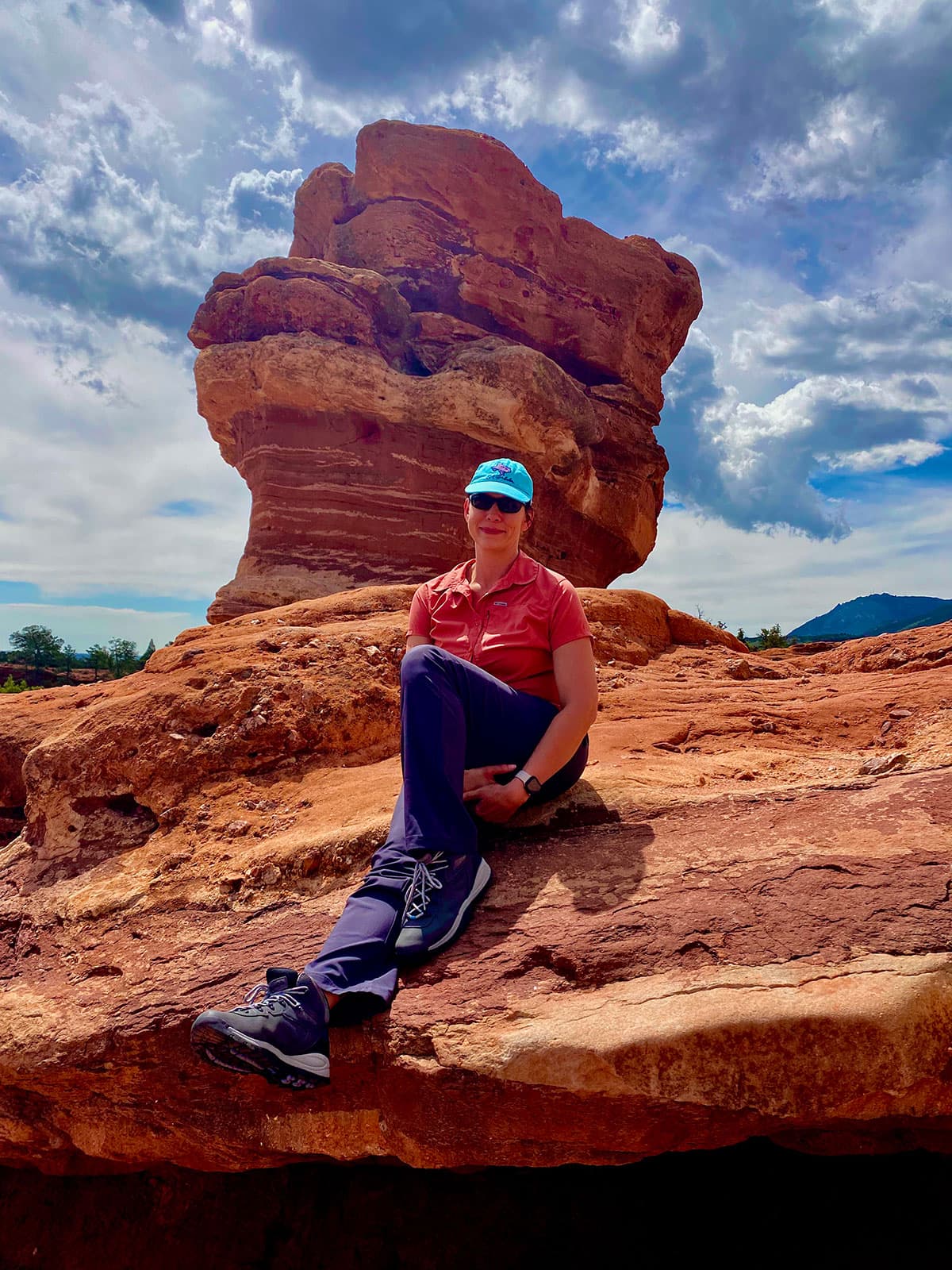 Jennifer sitting on Steamboat Rock beside Balanced Rock