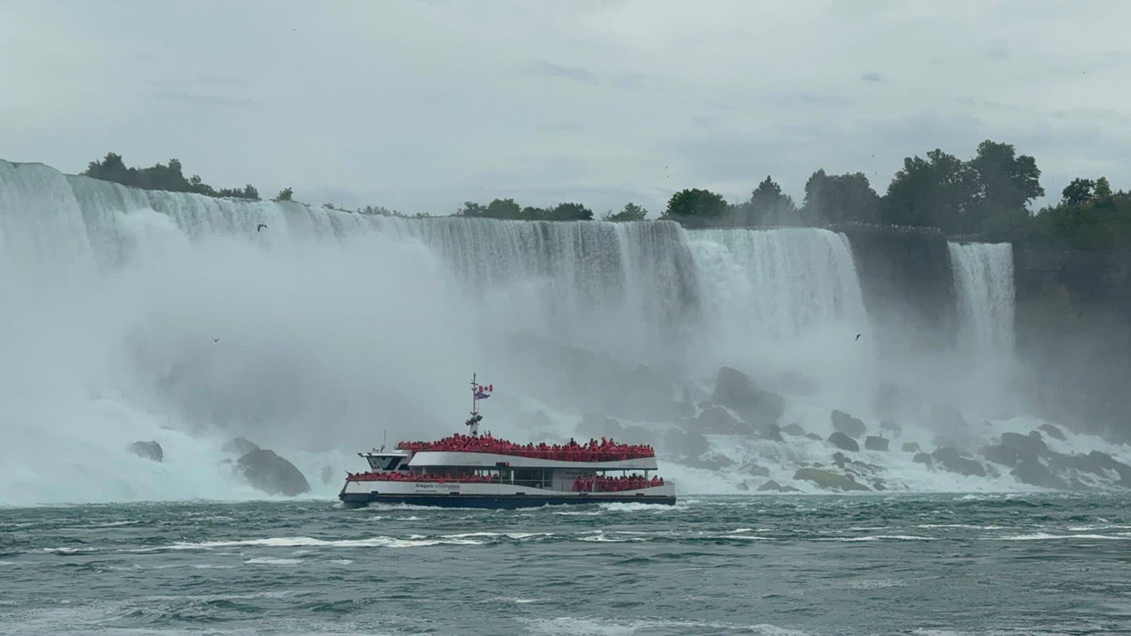 Tour boat carrying passengers into the mist below Niagara Falls