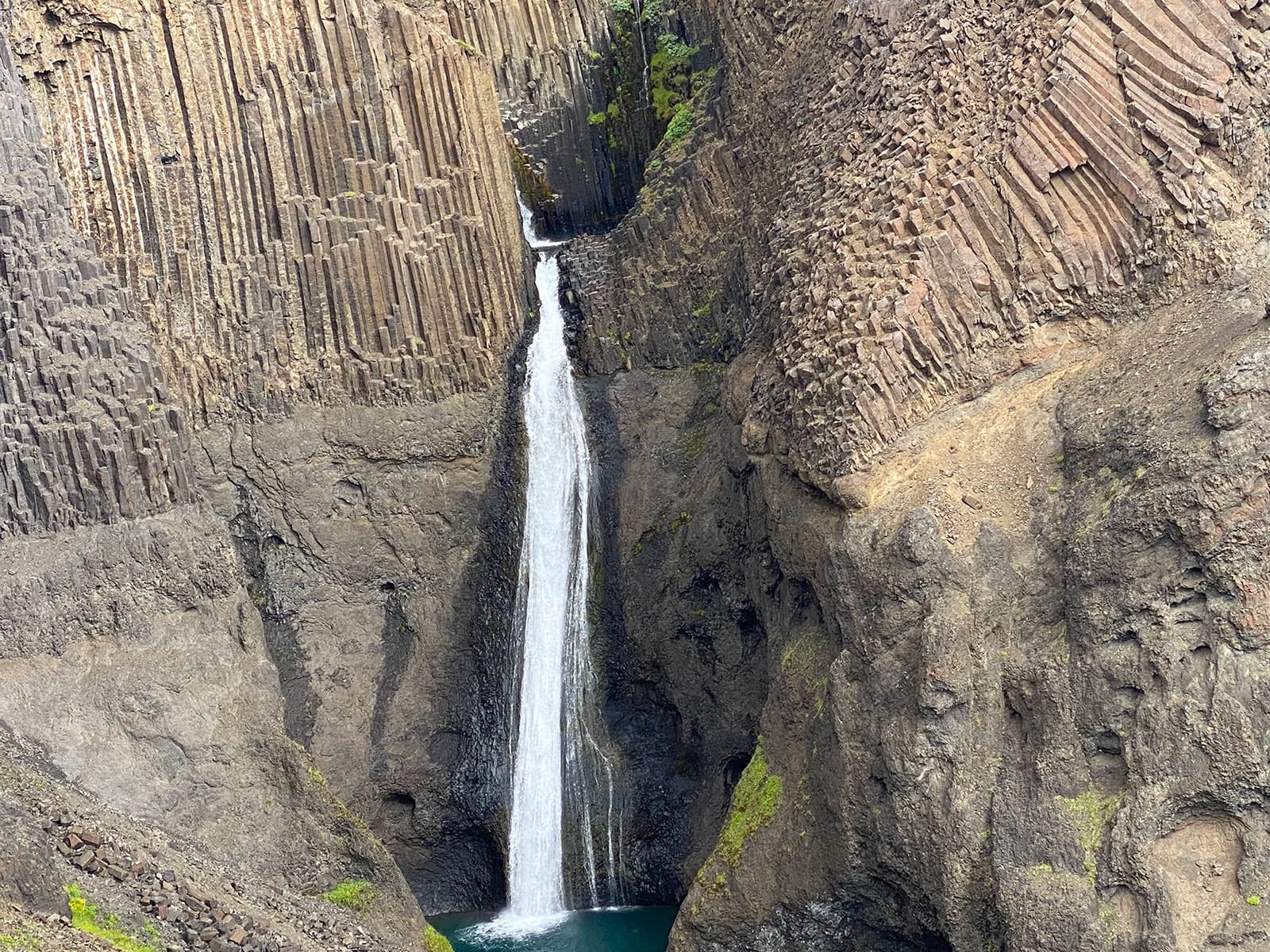 Hengifoss dropping between layered volcanic cliffs