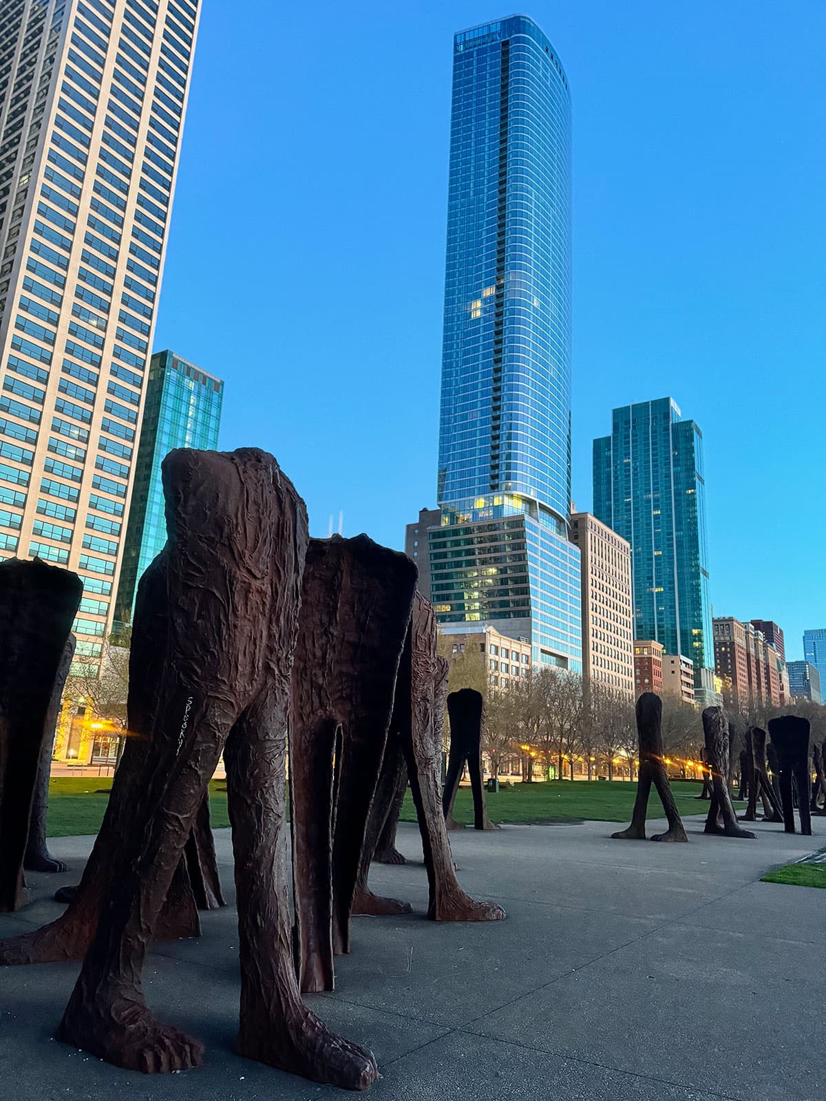 Headless cast-iron Agora figures beneath the Chicago skyline