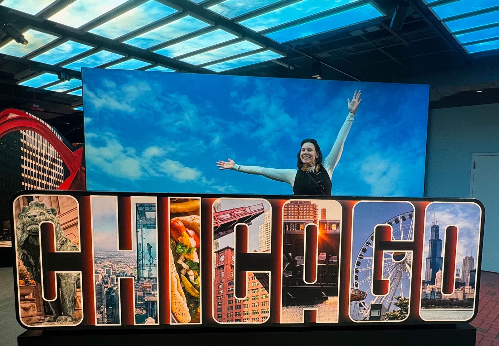 Jennifer posing behind a colorful CHICAGO sign