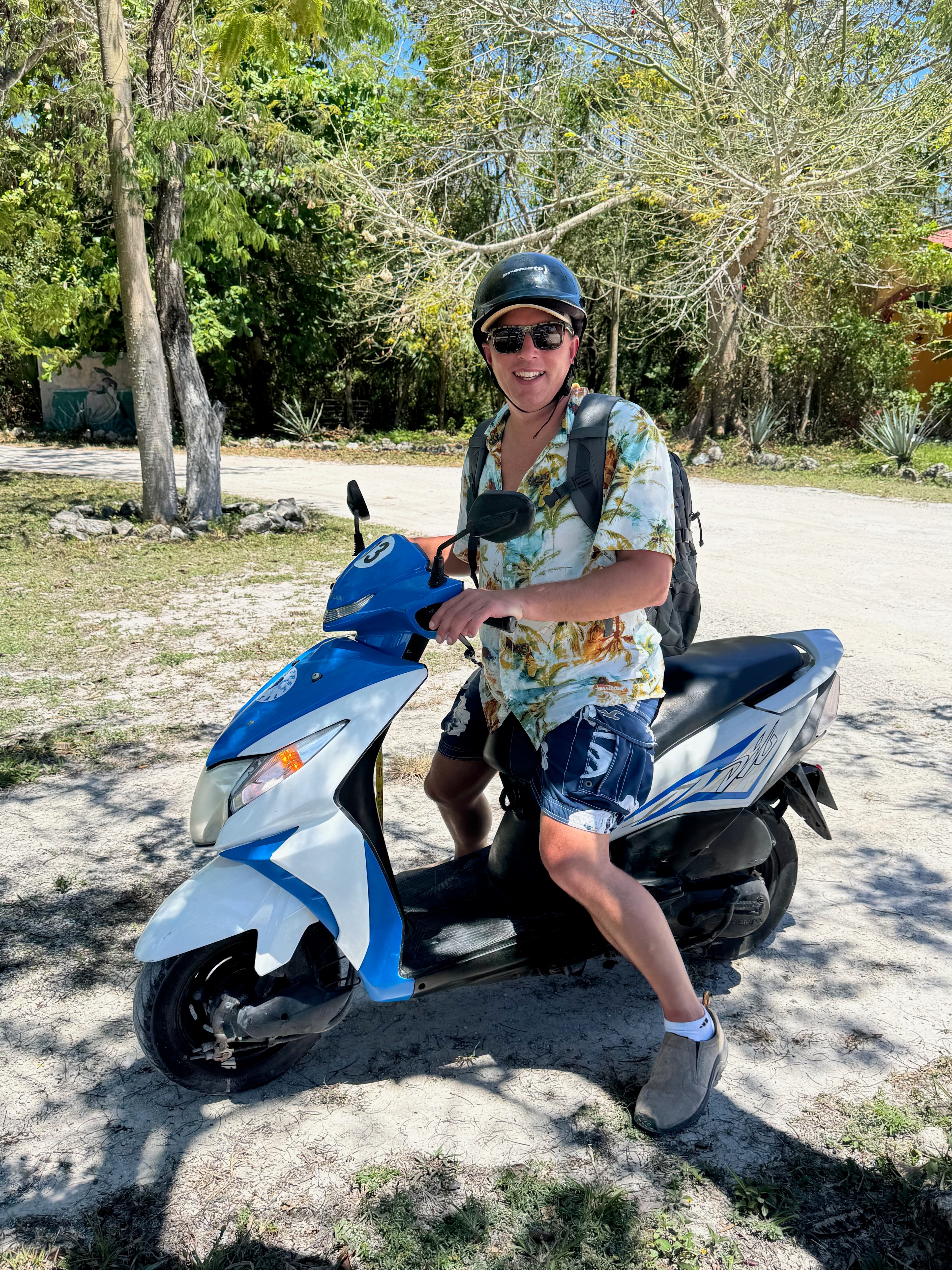 Kevin sitting on a blue-and-white scooter