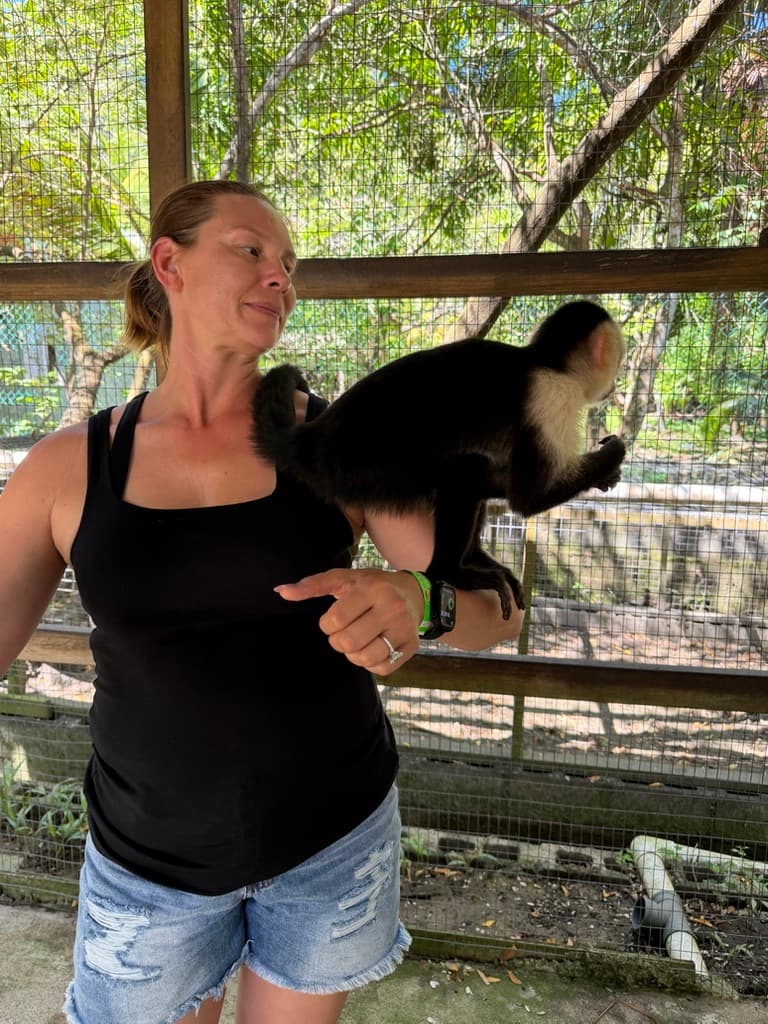 Jennifer with a capuchin monkey in an enclosed setting